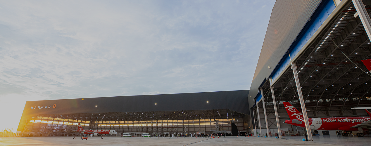 ADE aircraft maintenance, repair and overhaul (MRO) facility with AirAsia aircraft in a large hangar, promoting end-to-end fleet maintenance solutions.
