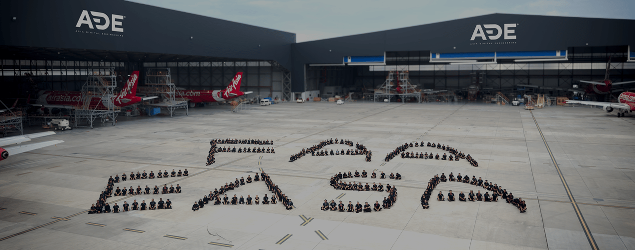 ADE aircraft maintenance, repair and overhaul (MRO) facility with AirAsia aircraft in a large hangar, promoting end-to-end fleet maintenance solutions.